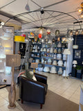 Interior of a home decor store with various lighting fixtures and furniture.